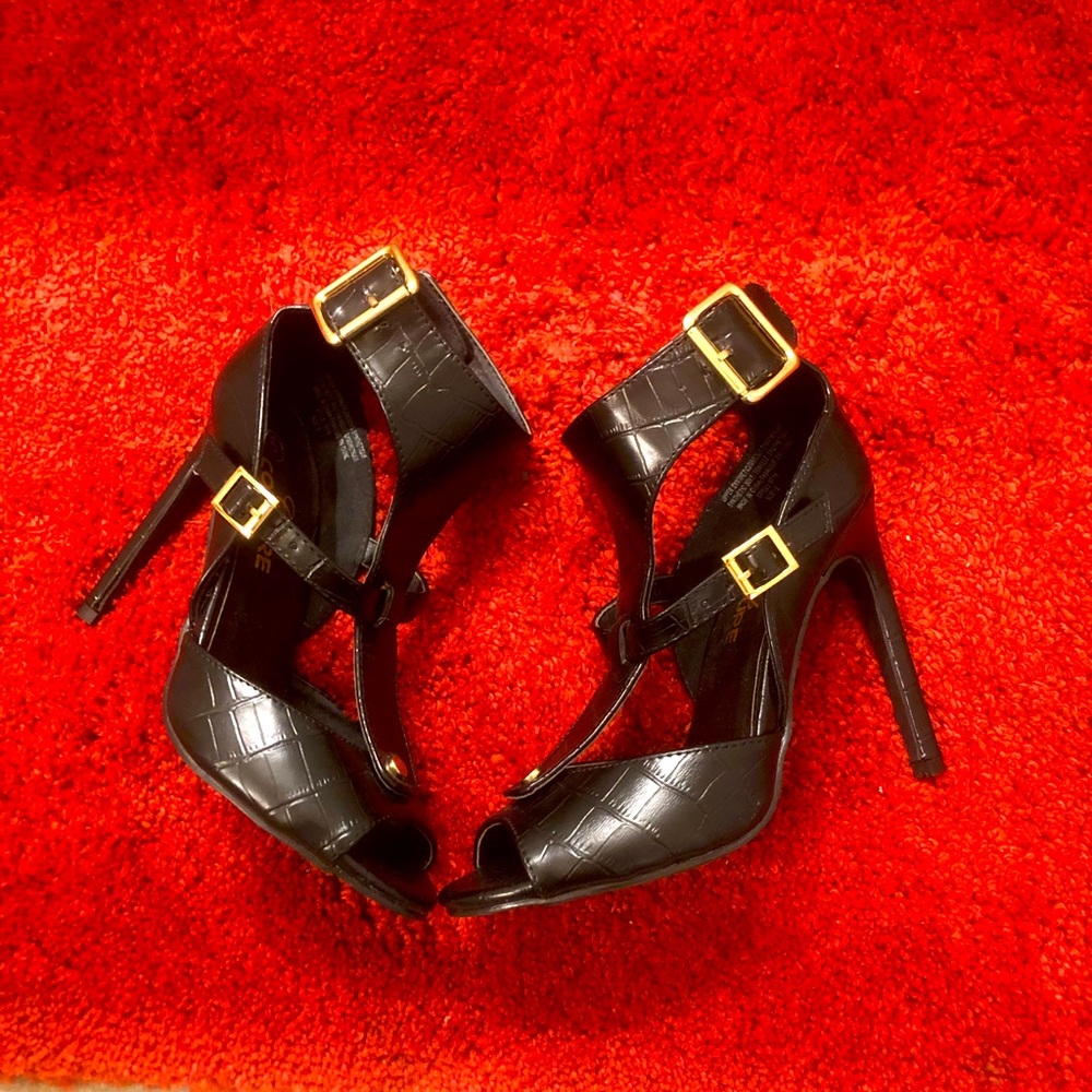 Brand new black high heels. Classy look with golden buckles.